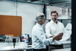 © Joseffson/Westend61 - Mature entrepreneurs discussing over business plan while standing at industry