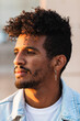 © NOVELLIMAGE/Westend61 - Close-up of thoughtful young man wearing cross shaped earring