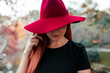 © Manu Reyes/Westend61 - Close-up of mid adult woman wearing red hat in park