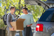 © Tetra Images/Tetra Images - Father helping teenage son (16-17) packing to college