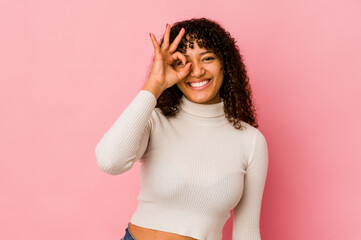 Young african american afro woman isolated excited keeping ok gesture on eye.