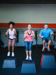 © Erik Isakson/Tetra Images - Three people in step aerobics class