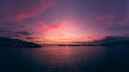 Beautiful sunset, aerial view of the beach, acapulco city seen from above. Travel and vacation concept. Colorful sunset on the beach