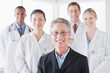 © Rob Lewine/Tetra Images - Group portrait of smiling doctors