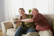 © Rob Lewine/Tetra Images - Couple fighting for tv remote
