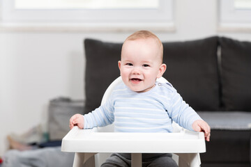 Wall Mural - Portrait of Young Baby Boy in High Chair