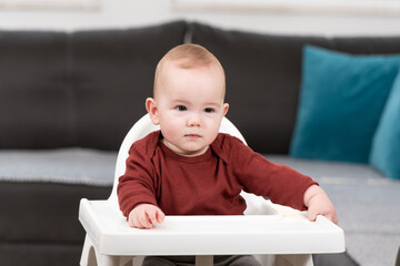 Wall Mural - Beautiful Child Sitting in High Chair