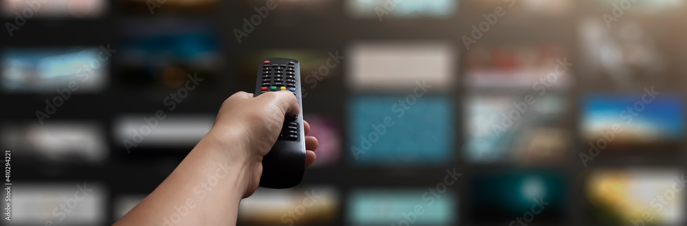 concept - man with his remote control watching tv in his living room - obrazy, fototapety, plakaty 