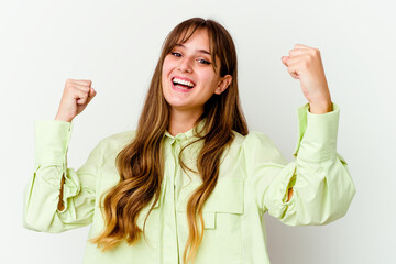 Young caucasian cute woman isolated on white background cheering carefree and excited. Victory concept.