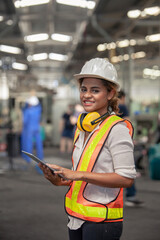 Engineer Female in using Tablet in Foundry worker in factory on the machine. portrait of an industrial Femal engineer with tablet in a factory.