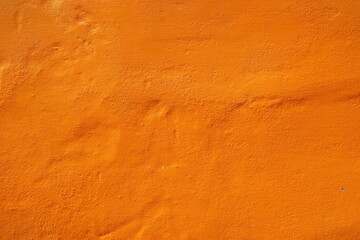 Wall Mural - orange paint color on stucco wall texture for background.