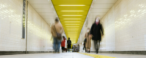 Wall Mural - Pedestrians wearing surgical masks in subway station, Tokyo　マスクをつけた人々 東京の地下鉄駅の構内