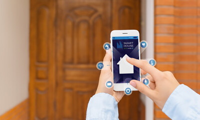 Sticker - Woman using application of smart home automation near house outdoors