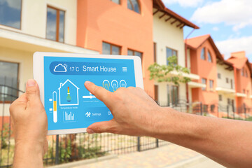 Sticker - Man using application of smart home automation near house outdoors