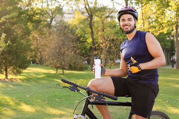 Sticker - Male cyclist with bicycle showing thumb-up outdoors