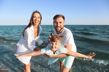 Canvas Print - Happy family playing on sea beach