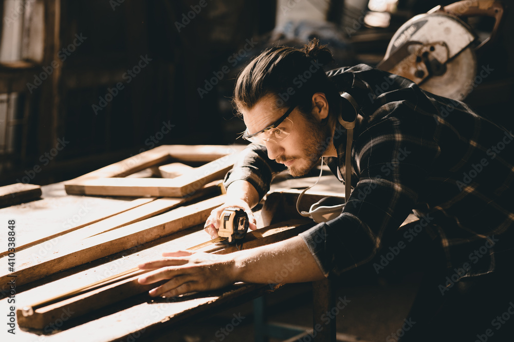 Carpenter man attend to making masterpiece woodworks handcrafted furniture fine measure in wood workshop. - obrazy, fototapety, plakaty 