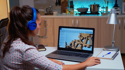 Wall Mural - Design engineer working on a 3D component in CAD program on laptop from home. Industrial female employee studying prototype idea on personal computer showing cad software on device display