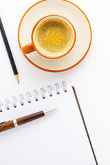 Wall Mural - Cup of coffee, notepad and pen on a white wooden background. Workplace top view