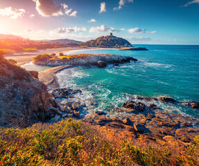 Great sunrise on popular tourist destination - Acropoli di Bithia with Torre di Chia tower on background. Fabulous morning view of Sardinia island, Italy, Europe. Traveling concept background