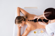 © LIGHTFIELD STUDIOS - top view of young woman getting hot stone massage in spa salon