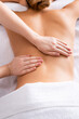 © LIGHTFIELD STUDIOS - partial view of masseur massaging client on massage table