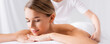 © LIGHTFIELD STUDIOS - Young woman lying on massage table near masseur on blurred background, banner