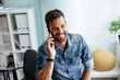 © JustLife - Businessman in office using the phone. Handsome businessman talking to the phone.