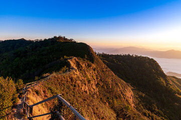 Wall Mural - Landscape and starscape of the mountain and sea of mist in winter sunrise view from top of Phu Chi Dao mountain , Chiang Rai, Thailand