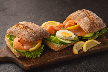 Wall Mural - Sandwiches with smoked salmon, salad, cucumbers and eggs.