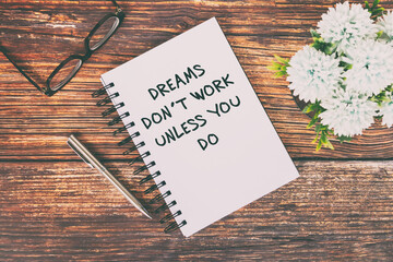 Wall Mural - Motivational and Inspirational Quotes text on notepad - Dreams don't work unless you do.