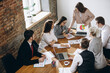 © master1305 - Diagram. Female speaker giving presentation in hall at university workshop. Audience or conference hall. Participants, co-workers listening at the table. Scientific, business event, training. Top view