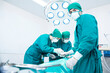 © Thirawatana - The surgeon team is working in the operating room. Surgeon is operating a patient in an operating in a hospital.