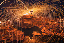 Burning Steel Wool On The Rock Near The River At Sam Phan Bok In Ubonratchathani Unseen In Thailand. The Grand Canyon Of Thailand.