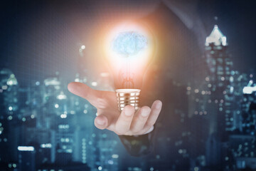 Light bulb with brain inside the hand of the businessman as business idea concept.