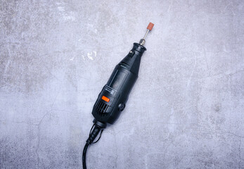 Poster - Electric mini drill on concrete background, top view space for text