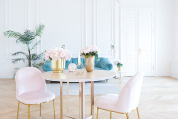 chic spacious light room in an old mansion in the classical style of the 19th century with a high ceiling decorated with stucco on white walls