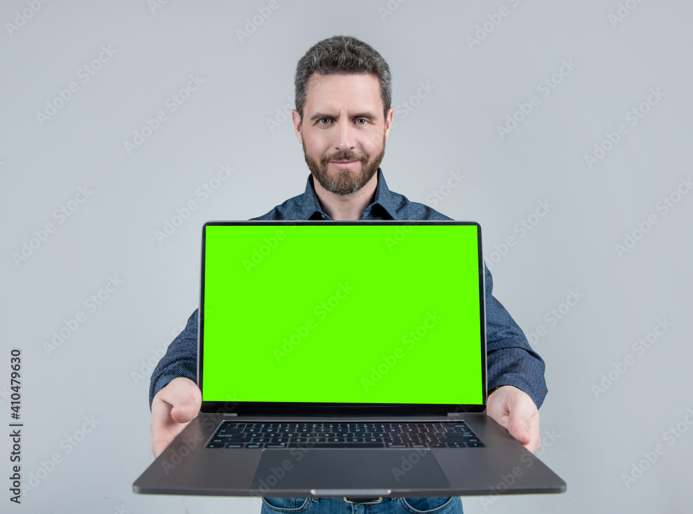 Bearded computer guy hold open laptop with neon green screen for copy ...