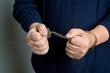 © Евгений Порохин - Men's hands in handcuffs close up
