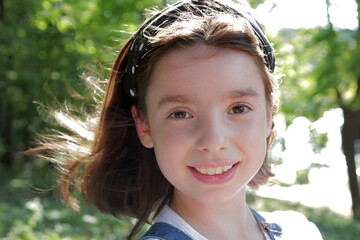 
beautiful girl rejoices in the spring weather in the park.