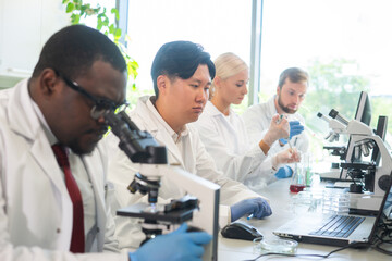 Wall Mural - scientist and students working in lab. doctor teaching interns to make analyzing research. biotechno