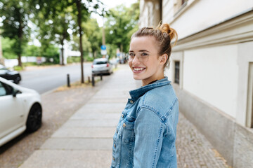 Wall Mural - Young woman turning to glance behind her