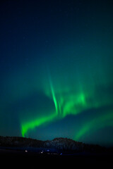aurora borealis over the mountains in norway. northern lights
