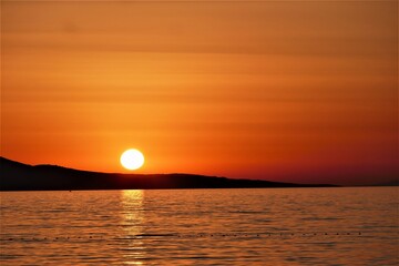 Wall Mural - Orange sunset in the sea and reflection