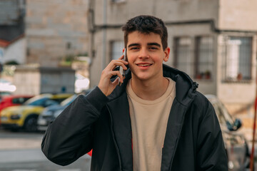 Canvas Print - young man with mobile phone on the city street