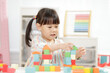 © M-image - young girl playing creative toy blocks for homeschooling