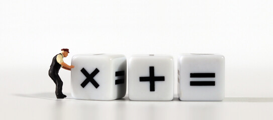 white dice with mathematical math symbols and miniature man
