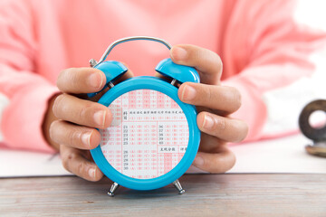 Wall Mural - The abstract alarm clock with the screen inlaid with the college entrance examination answer card