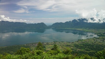 Wall Mural - Timelapse panoramic view of Maninjau Lake at West Sumatra, Indonesia. Beautiful nature Indonesia landscape with mountains background.