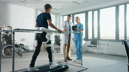 Aufkleber - Modern Hospital Physical Therapy: Patient with Injury Walks on Treadmill Wearing Advanced Robotic Exoskeleton Legs. Physiotherapy Rehabilitation Scientists, Engineers, Doctors use Tablet Computer